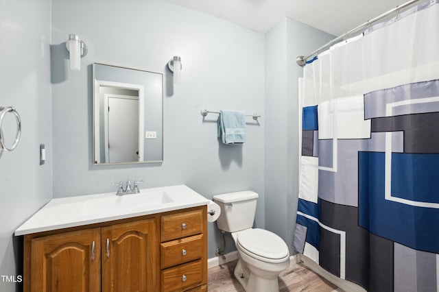 bathroom featuring toilet, vanity, and a shower with shower curtain