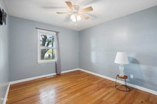 empty room with light wood-type flooring, ceiling fan, and baseboards