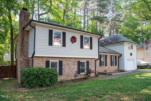 tri-level home with a chimney, brick siding, and a garage