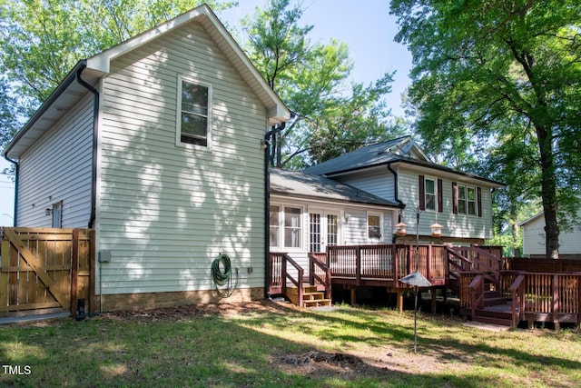 rear view of property featuring a deck, a gate, and french doors