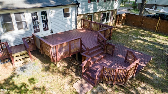 deck featuring a fenced backyard and french doors