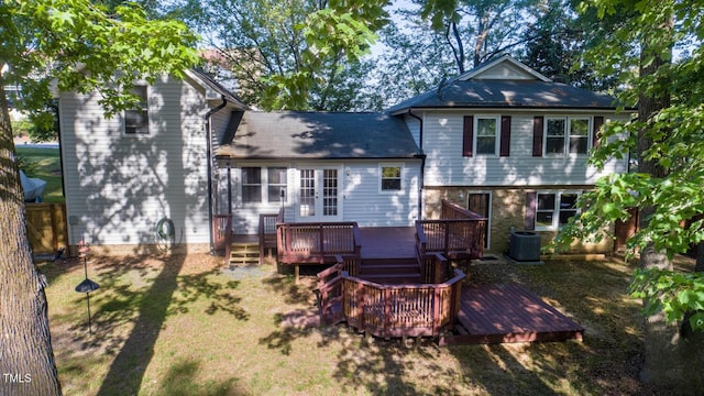 rear view of property with central AC unit, a wooden deck, and french doors