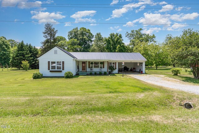 80 Lewis Moody Rd, Bear Creek, NC 27207 - ranch-style house featuring driveway, an attached carport, a front lawn, metal roof, and a porch