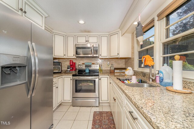 80 Lewis Moody Rd, Bear Creek, NC 27207 - kitchen featuring appliances with stainless steel finishes, a sink, light tile patterned floors, tasteful backsplash, and recessed lighting