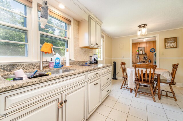 80 Lewis Moody Rd, Bear Creek, NC 27207 - kitchen featuring light tile patterned floors, a sink, ornamental molding, and light stone countertops