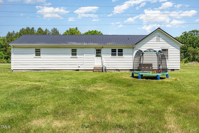 80 Lewis Moody Rd, Bear Creek, NC 27207 - back of property featuring entry steps, crawl space, metal roof, and a trampoline