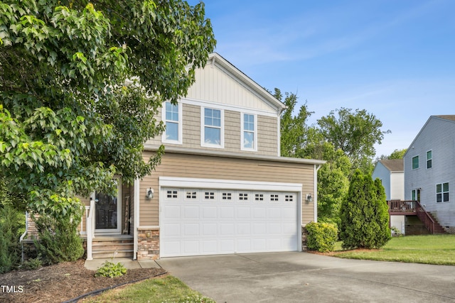 view of front of home featuring an attached garage, concrete driveway, stone siding, and board and batten siding