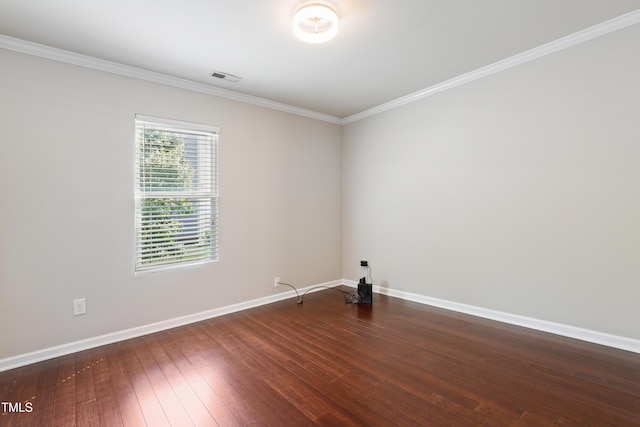 spare room featuring baseboards, crown molding, and wood-type flooring