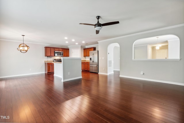 unfurnished living room with ceiling fan, baseboards, recessed lighting, arched walkways, and dark wood-type flooring
