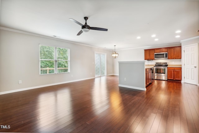 unfurnished living room featuring crown molding, a ceiling fan, recessed lighting, dark wood-style flooring, and a chandelier