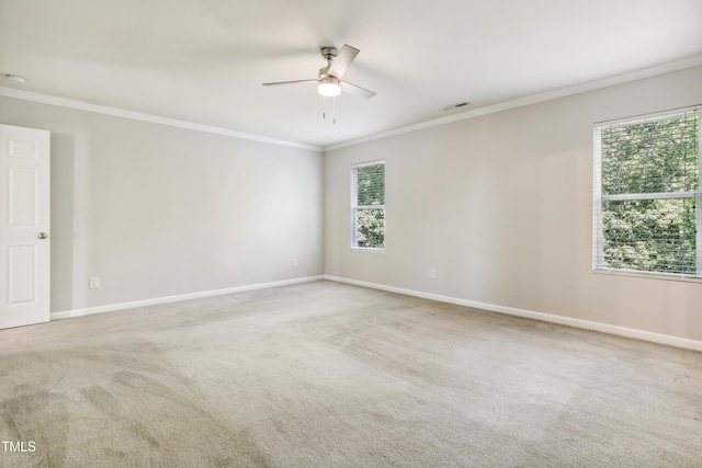 unfurnished room featuring crown molding, ceiling fan, carpet, and baseboards