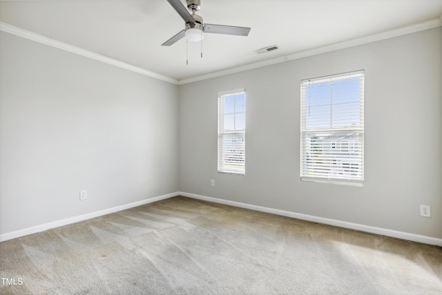 unfurnished room featuring crown molding, carpet, baseboards, and ceiling fan