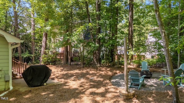 view of yard with a fire pit