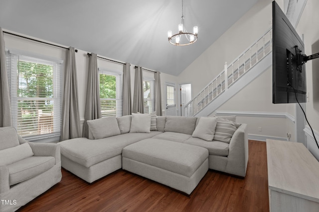 living room with a chandelier, lofted ceiling, dark wood-style floors, and stairway