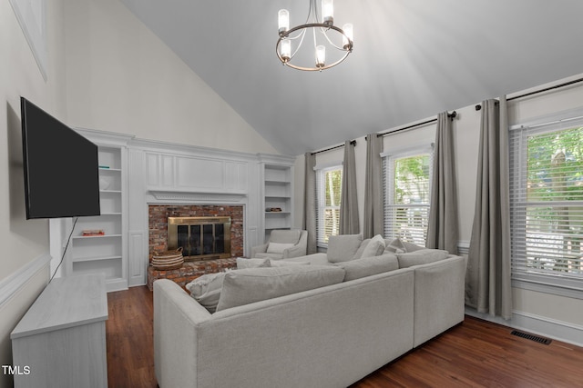 living area featuring a chandelier, dark wood-style flooring, a fireplace, lofted ceiling, and baseboards