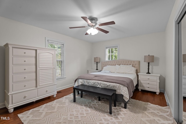 bedroom featuring wood finished floors, baseboards, and ceiling fan