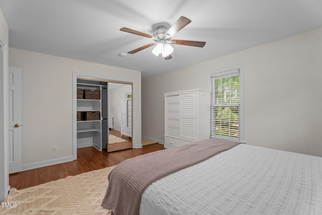 bedroom with wood finished floors, baseboards, and ceiling fan