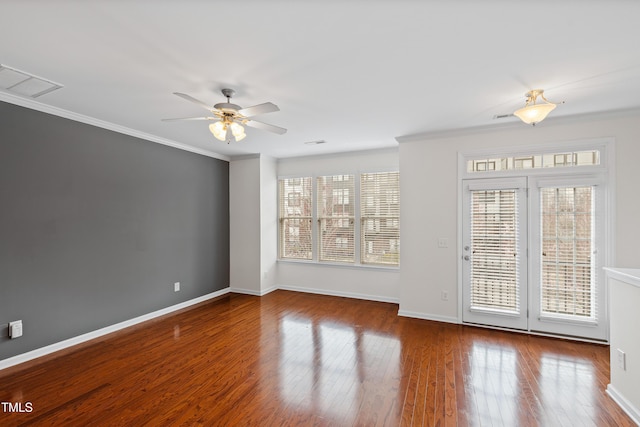 empty room with crown molding, ceiling fan, wood finished floors, and baseboards