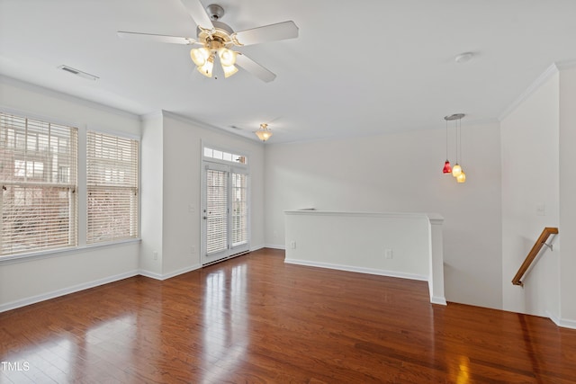 unfurnished living room with crown molding, wood finished floors, a ceiling fan, and baseboards