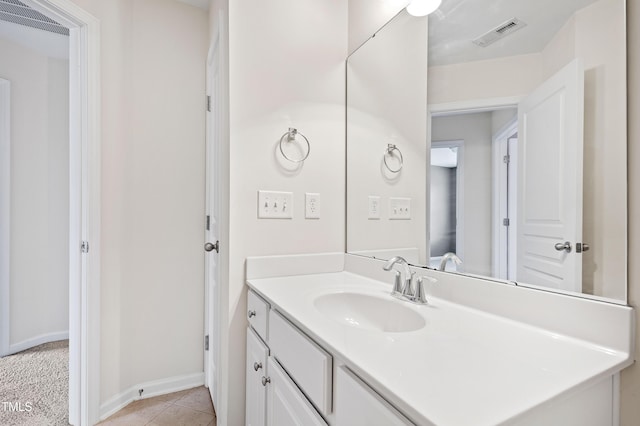 bathroom featuring vanity, tile patterned flooring, and baseboards