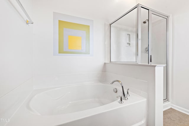 full bath with a bath, a shower stall, and tile patterned flooring