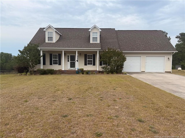 new england style home featuring an attached garage, driveway, a porch, and a front lawn