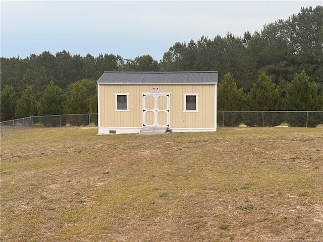 view of outbuilding featuring an outdoor structure and a forest view