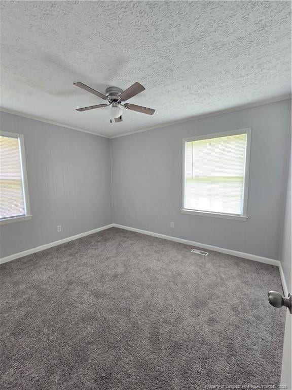 6841 Radial Dr, Fayetteville, NC 28311 - empty room with a textured ceiling, carpet floors, ceiling fan, baseboards, and ornamental molding