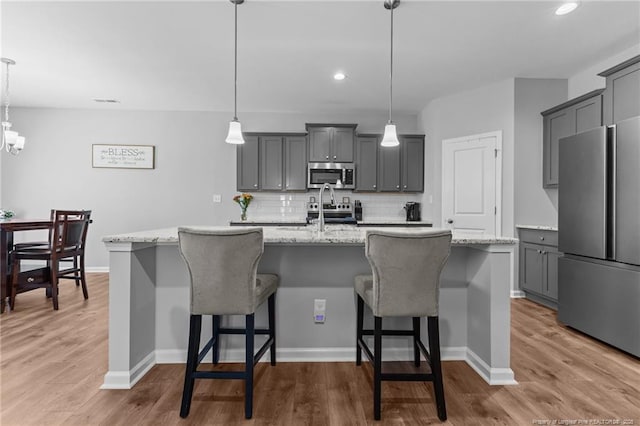 308 Laurel Lake Rd, Salemburg, NC 28385 - kitchen featuring appliances with stainless steel finishes, gray cabinets, backsplash, wood finished floors, and recessed lighting