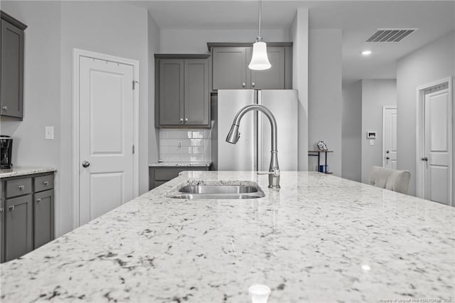 308 Laurel Lake Rd, Salemburg, NC 28385 - kitchen featuring a sink, light stone counters, backsplash, and recessed lighting
