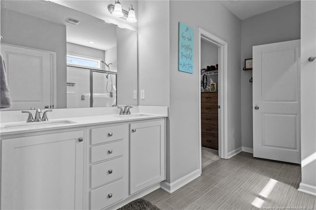 308 Laurel Lake Rd, Salemburg, NC 28385 - full bath with a shower stall, baseboards, double vanity, and a walk in closet