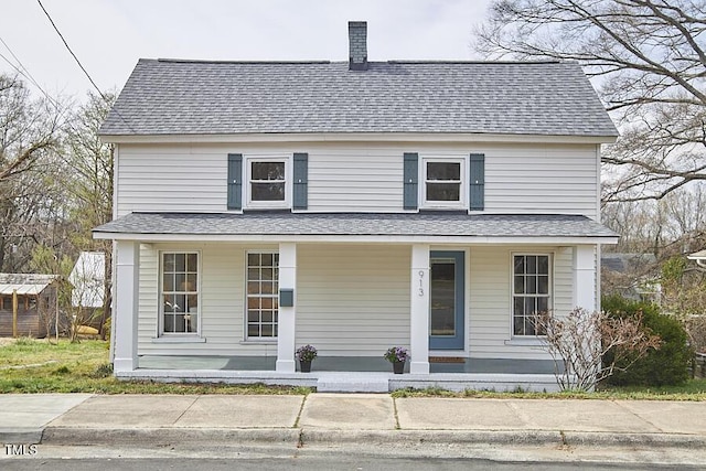 view of front of property with a porch, roof with shingles, and a chimney