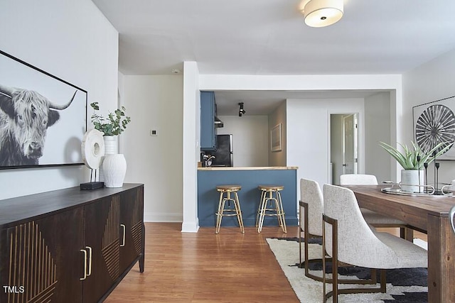 dining room with wood finished floors and baseboards