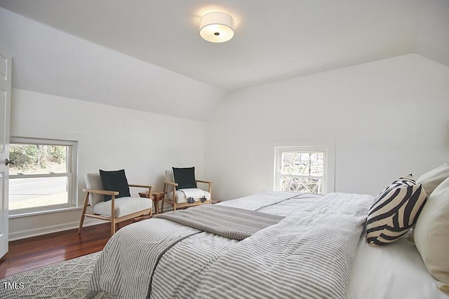 bedroom featuring vaulted ceiling, wood finished floors, and baseboards