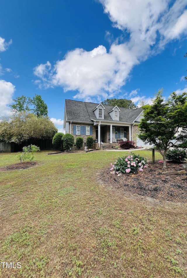 cape cod-style house with a front yard, brick siding, and covered porch