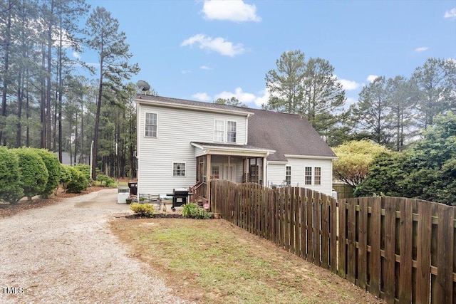 151 Donnibrook Run, Fuquay Varina, NC 27526 - back of property with dirt driveway and a shingled roof