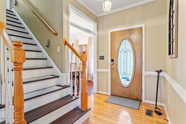 151 Donnibrook Run, Fuquay Varina, NC 27526 - entryway with wood finished floors, healthy amount of natural light, ornamental molding, stairway, and baseboards