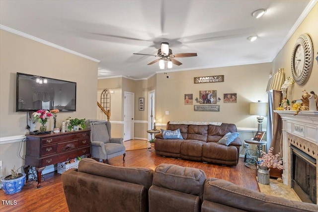 151 Donnibrook Run, Fuquay Varina, NC 27526 - living area featuring wood finished floors, ceiling fan, a fireplace, and crown molding