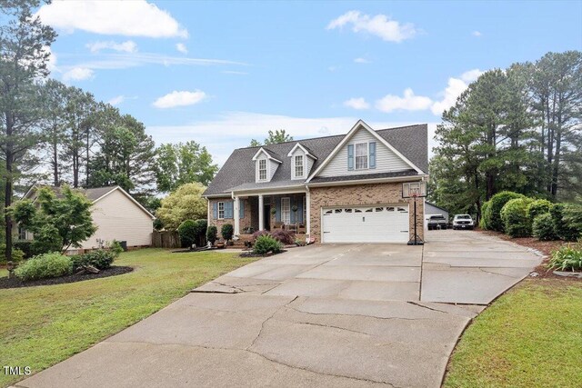 151 Donnibrook Run, Fuquay Varina, NC 27526 - view of front of property featuring driveway, brick siding, covered porch, a front lawn, and a garage