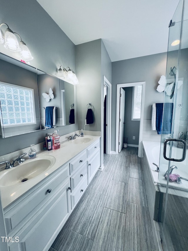 151 Donnibrook Run, Fuquay Varina, NC 27526 - full bathroom featuring double vanity, a bath, a stall shower, and baseboards