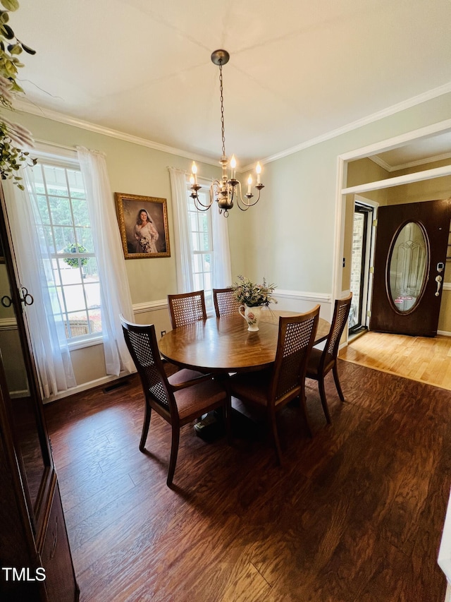 151 Donnibrook Run, Fuquay Varina, NC 27526 - dining space with a chandelier, dark wood-style floors, crown molding, and baseboards