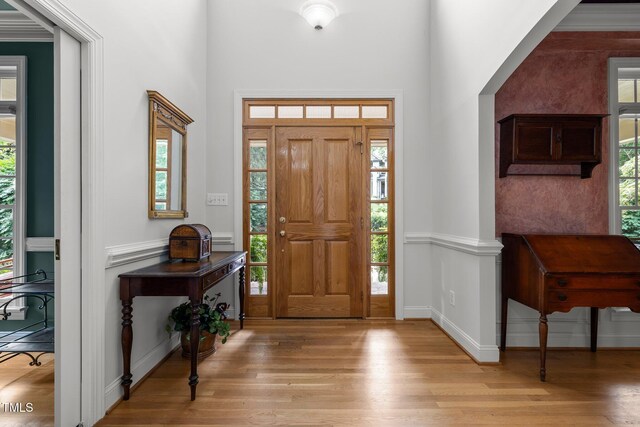 entrance foyer with light wood finished floors and baseboards