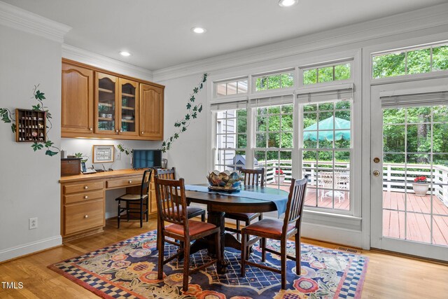 dining room featuring healthy amount of natural light, ornamental molding, light wood finished floors, baseboards, and recessed lighting