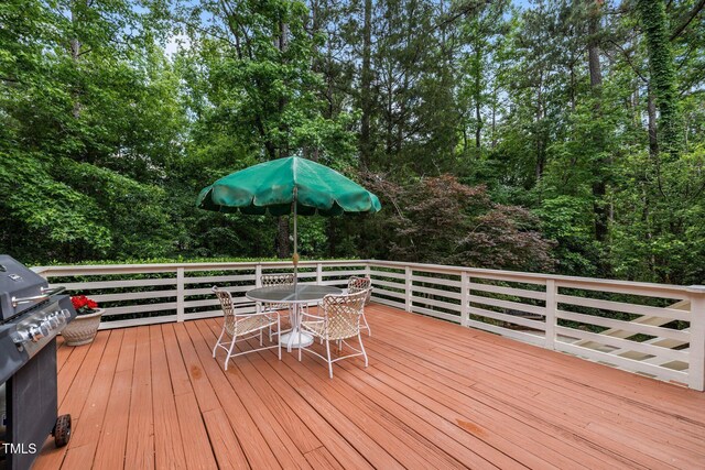 wooden deck featuring outdoor dining area and area for grilling