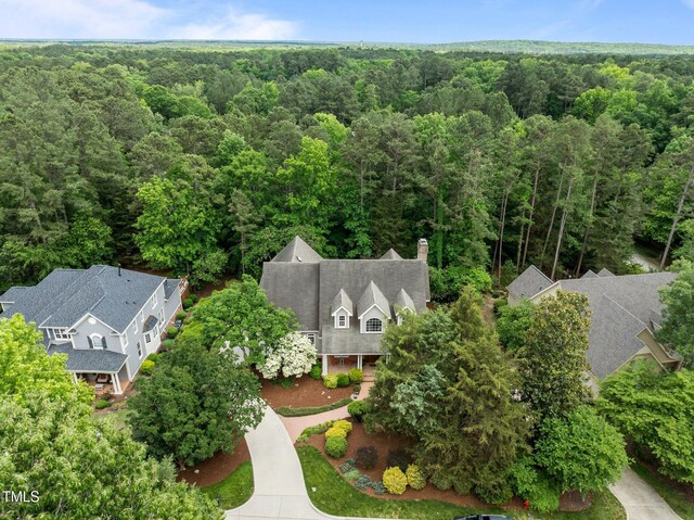 view from above of property with a heavily wooded area