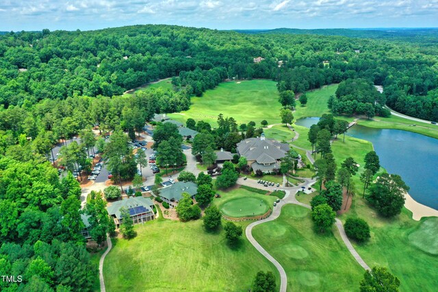 aerial overview of property's location featuring a forest, a large body of water, and a local golf course