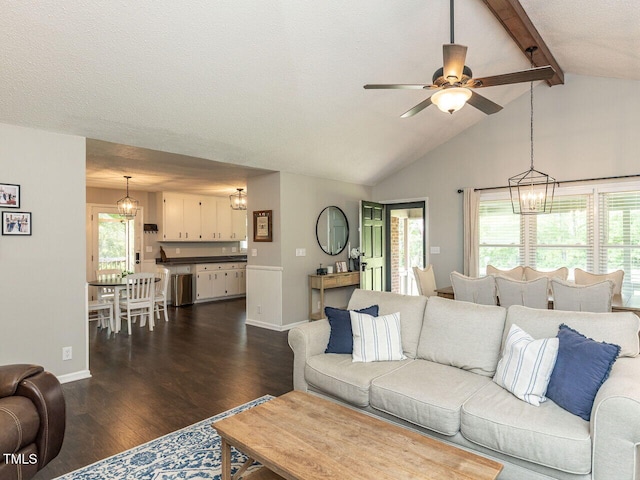 living area with a chandelier, dark wood-type flooring, ceiling fan, and baseboards