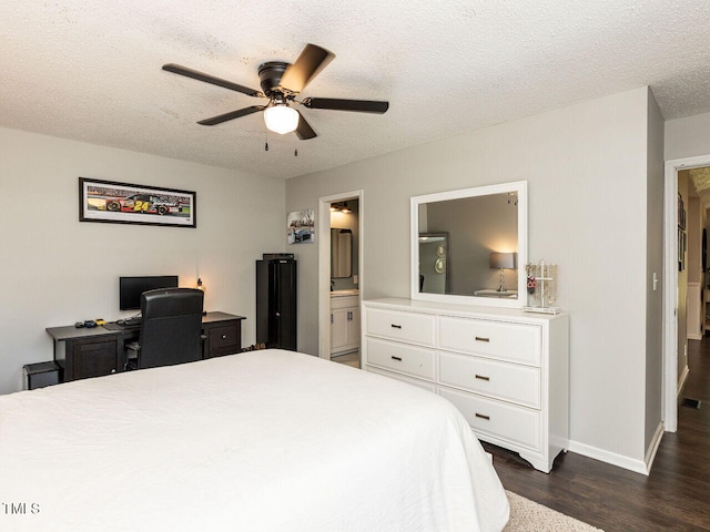 bedroom with dark wood-style flooring, a textured ceiling, baseboards, ensuite bath, and a ceiling fan