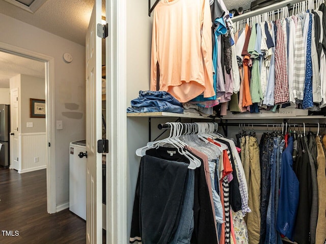 walk in closet featuring wood finished floors and attic access