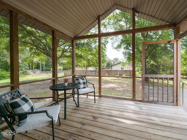 sunroom / solarium featuring lofted ceiling